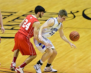 YOUNGSTOWN, OHIO - JANUARY 25, 2014: Nicky Cannone #24 of West Middlesex pokes the ball away from the control of Kyle Dixon #21 of Poland during the first half of Sunday evenings game at Covelli Centre. (Photo by David Dermer/Youngstown Vindicator)