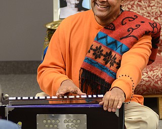 Katie Rickman | The Vindicator.Kedar Acharyaji chants as he plays a harmonium at a chanting and meditation program at Bella Nitesh on Jan. 14, 2015. Over a dozen people gathered to hear Acharyaji speak about finding inner peace and power within.