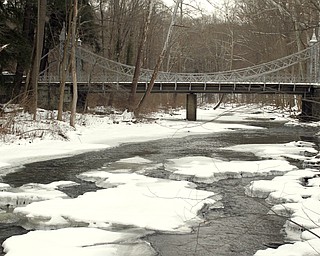        ROBERT K. YOSAY  | THE VINDICATOR..Almost frozen over with ice the Silver Bridge withstands another winter ..With tempertatures hovering around zero Mill Creek Metroparks has started its annual ice show by nature as ice forms on creeks to lakes to waterfalls