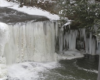        ROBERT K. YOSAY  | THE VINDICATOR..Lantermans Mill Falls -  bathed in ice and water.. forms.. stalactites... nearby as water freezes.....the With tempertatures hovering around zero Mill Creek Metroparks has started its annual ice show by nature as ice forms on creeks to lakes to waterfalls