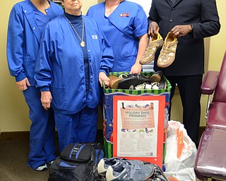 Katie Rickman | The Vindicator.Staff from Ankle & Foot Care Center in Boardman pose with donated shoes that L-R Lindsay Remsey, Elizabeth Emch (OKAY) Cara Adkins, and Elijah Kahn (of the Red Cross) on Wednesday, Jan. 14, 2015.