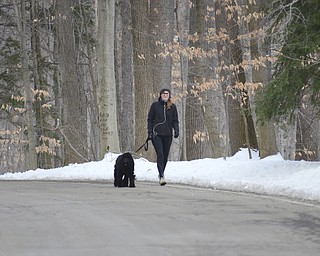 Katie Rickman | The Vindicator.Chrissy Bailey of Youngstown walks her parents dog named  Rosie through Mill Creek MetroPark on Friday, Jan. 16, 2015.