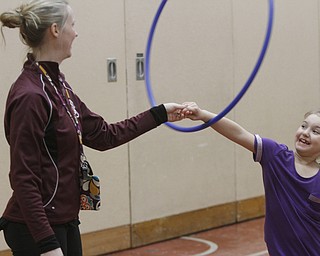        ROBERT K. YOSAY  | THE VINDICATOR..team effort as  Peyton Abighanem and TKendal Daltorio, PE teacher  spnin a hula hoop ..and  classes at Stadium Drive  Elementary in Boardman School are participating in a jump-roping /hula-hoope  event to raise money for the American Heart Association.