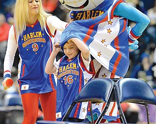Globie, the team’s mascot, covers the face of fan Dominic Tarnoci with his jersey during a game of musical 
chairs prior to the start of the game. As usual, the Globetrotters topped the Generals, this time by a score of
69-67.
