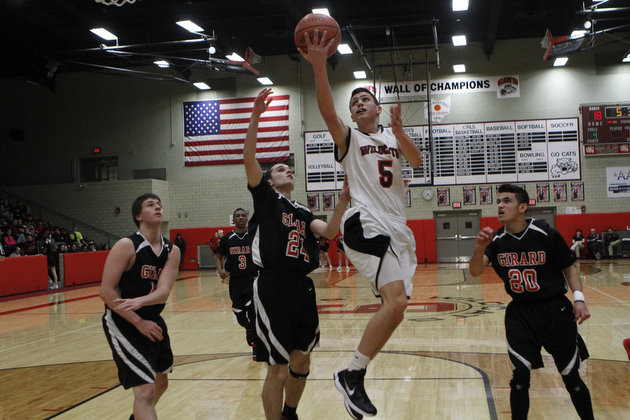 Andrew Carbon (5) of Struthers goes up for a layup while being defended by Girard's Mark Standohar (24) during the first half of Friday nights matchup at Struthers High School.   Dustin Livesay  |  The Vindicator  1/30/15  Struthers High School.