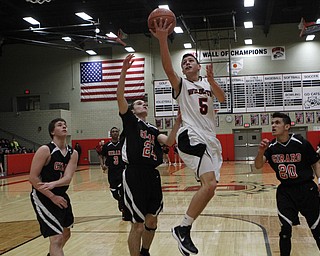 Andrew Carbon (5) of Struthers goes up for a layup while being defended by Girard's Mark Standohar (24) during the first half of Friday nights matchup at Struthers High School.   Dustin Livesay  |  The Vindicator  1/30/15  Struthers High School.