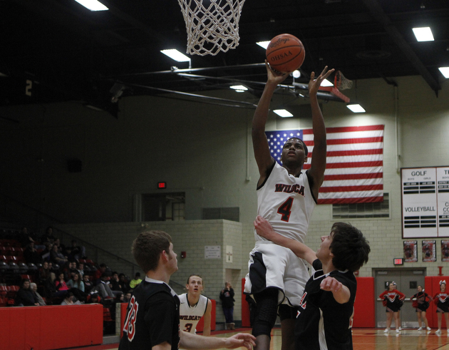 Ray Phifer (4) of Struthers goes up for a layup while being defended by Girard's Dylan O'Hara during the first half of Friday nights matchup at Struthers High School.   Dustin Livesay  |  The Vindicator  1/30/15  Struthers High School.
