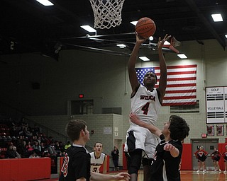 Ray Phifer (4) of Struthers goes up for a layup while being defended by Girard's Dylan O'Hara during the first half of Friday nights matchup at Struthers High School.   Dustin Livesay  |  The Vindicator  1/30/15  Struthers High School.