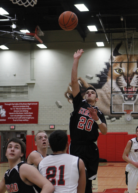 Girard's Chaston Williams (20) puts up a jump shot while being defended by Austin Yemma (21) of Struthers during the first half of Friday nights matchup at Struthers High School.   Dustin Livesay  |  The Vindicator  1/30/15  Struthers High School.