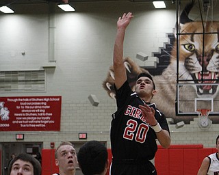Girard's Chaston Williams (20) puts up a jump shot while being defended by Austin Yemma (21) of Struthers during the first half of Friday nights matchup at Struthers High School.   Dustin Livesay  |  The Vindicator  1/30/15  Struthers High School.