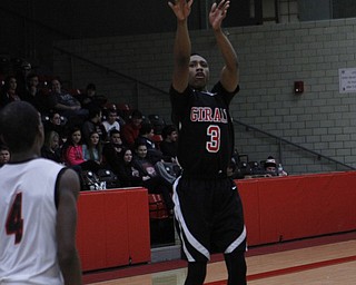 Girard's DeOnte Brown (3) puts up a 3-pointer while being defended by Ray Phifer (4) of Struthers during the second half of Friday nights matchup at Struthers High School.   Dustin Livesay  |  The Vindicator  1/30/15  Struthers High School.
