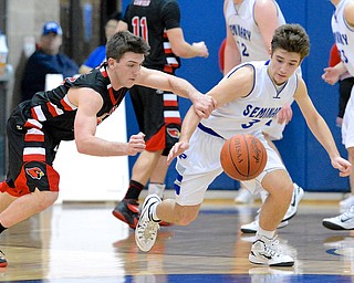 Jeff Lange | The Vindicator  Canfield's Mike Yourtowsky (left) and Seminary's Nick Gajdos (right) take to the floor as they both rush for possession of the ball during second half action at Poland High School, Friday night.