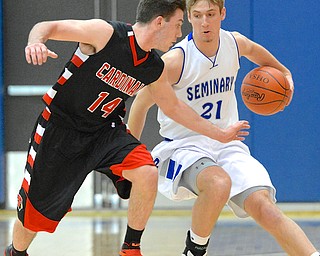 Jeff Lange | The Vindicator  Poland's Kyle Dixon (21) dribbles the ball around Canfield's Mike Yourtowsky during second half action at Poland High School, Friday night.