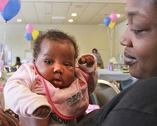 William D. Lewis The Vindicator  Tia Lindsey and her daughter Je'Mela Edwards, 2 months, take in the sights t the city baby shower Monday at the McGuffey Center. They are from Youngstown.