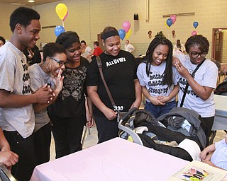 William D. Leiws The Vindicator Victoria Pettway shows her son Bryson Gilmore, 3 months, to a group of youth from a volunteer organization called Dream Chasers of the next generation during city baby shower Sunday at McGuffey Center. from left they are Tray'quan West, Trayvon West, Sade' Poindexter, Seannille McRae, Shiree Wilson, Mariah Poindester and Kay Kay Coney.