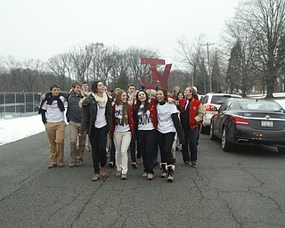        ROBERT K. YOSAY  | THE VINDICATOR...Cardinal Mooney High SchoolÕs colors are red and gold, but about 100 students donned white T-shirts Tuesday morning to show support for their ousted principal..John Young, principal since 2011, was terminated last week and the Catholic Diocese of Youngstown hasnÕt revealed the reason, calling it a personnel matter.