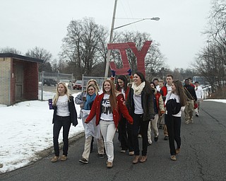        ROBERT K. YOSAY  | THE VINDICATOR...Cardinal Mooney High SchoolÕs colors are red and gold, but about 100 students donned white T-shirts Tuesday morning to show support for their ousted principal..John Young, principal since 2011, was terminated last week and the Catholic Diocese of Youngstown hasnÕt revealed the reason, calling it a personnel matter.
