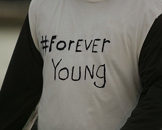        ROBERT K. YOSAY  | THE VINDICATOR...Cardinal Mooney High SchoolÕs colors are red and gold, but about 100 students donned white T-shirts Tuesday morning to show support for their ousted principal..John Young, principal since 2011, was terminated last week and the Catholic Diocese of Youngstown hasnÕt revealed the reason, calling it a personnel matter.