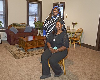 Katie Rickman | The Vindicator.Vickie Winphrie, Case Manager at YWCA stands behind Charmet Mitchell, Residential Aid for YWCA in one of the apartments on Wednesday, Jan. 21, 2015.