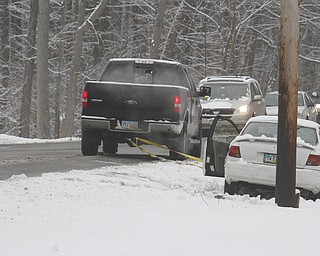        ROBERT K. YOSAY  | THE VINDICATOR..Slippery Shields Road in Canfield as a car slid off the road just  east of Raccoon was helped by a passerby .  Mahoning County Sheriff Dept .. stood by to direct rraffice  no injuries .. ..