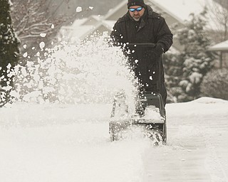        ROBERT K. YOSAY  | THE VINDICATOR..three inches of the white fluffy stuff came in today as Mark Larson ON Coral Way in Canfield had to fire up the snow blower...