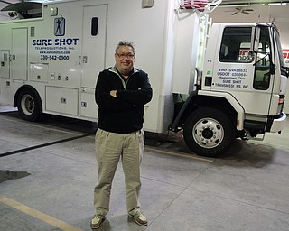 Katie Rickman | The Vindicator.Denny Kunce, owner and founder of Sure Shot Teleproductions, INC based out of New Middletown stands in front of one of the smaller satellite trucks at the Sure Shot location at 10214 Main St., New Middletown.