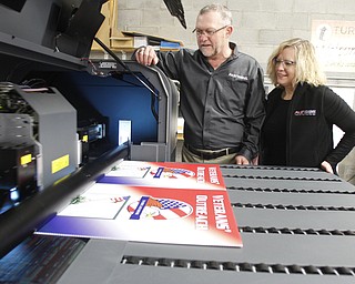  .          ROBERT  K. YOSAY | THE VINDICATOR..Jay and Penny Summer owners watch their  6 color printing machine that can print on just about anything and varying thicknesses...--FASTSIGNS¨ a sign, graphics and visual communications company that provides comprehensive visual marketing solutions to customers of all sizesÑacross all industriesÑto help them meet their business objectives and increase their business visibility....-30-