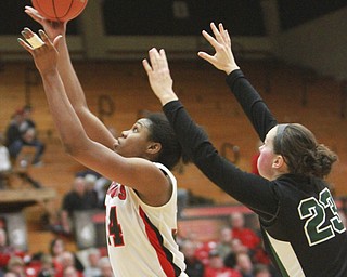William D. Lewis the vindicator  YSUs Latisha Walker(34)) shoots past Wright State's Tayler Stanton(21) and Courtney Boyd (23) during 1-22-15 action.