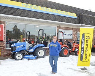 Katie Rickman | The Vindicator.Nichole Miner poses for a photo outside of her Canfield business on Friday, January 23, 2015. Miner’s business will be greatly effected by the work on the bridge and one of the signs has already been taken down.