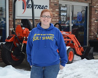 Katie Rickman | The Vindicator.Nichole Miner poses for a photo outside of her Canfield business on Friday, January 23, 2015. Miner’s business will be greatly effected by the work on the bridge and one of the signs has already been taken down.