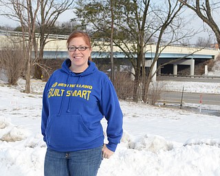 Katie Rickman | The Vindicator.Nichole Miner poses for a photo near the bridge on 224 in Canfield on Friday, January 23, 2015. Miner’s business will be greatly effected by the work on the bridge and one of the signs has already been taken down.