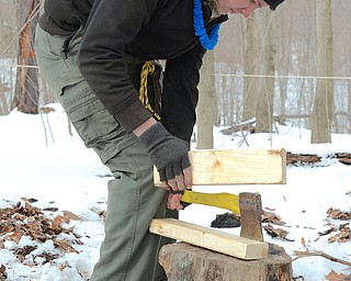 Jeff Lange | The Vindicator  Tyler Bartel of Troop 22 in Youngstown splits a 2"x4" safely by using another piece of wood to hit the ax, Saturday afternoon during the fire building activity at Camp Stambaugh in Canfield during the Klondike Derby.