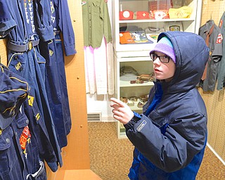 Jeff Lange | The Vindicator  Tommy Akers of Troop 54 Shark in Youngstown looks through the uniform room of the museum during an informational scavenger hunt as part of the Klondike Derby, Saturday afternoon at Camp Stambaugh