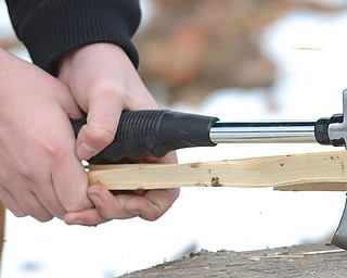 Jeff Lange | The Vindicator A member of the boy scouts splits a piece of wood safely by holding the ax against the wood and hitting on a flat surface, preventing any accidental cuts from the blade, Saturday afternoon at Camp Stambaugh during the Klondike Derby.