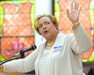 Jeff Lange | The Vindicator  Jaladah Aslam of the MLK Committee looks to the screen as she delivers her speech on voting statistics in the Mahoning area, Monday morning during the MLK Community Workshop at First Presbyterian Church in Youngstown.
