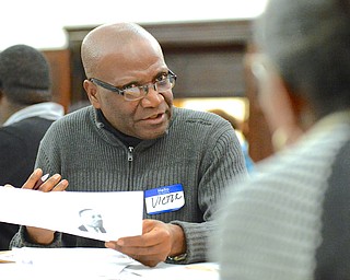 Jeff Lange | The Vindicator  Dr. Victor Wan-Tatah of YSU's Pan-African Studies Program discusses with members of his table the strengths and weaknesses that can help or hinder the ability to live civilly in Mahoning County, Monday morning at the First Presbyterian Church in Youngstown during the MLK Community Workshop.