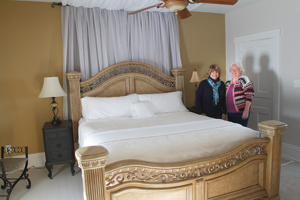Jan Pumphrey, left, and Brenda Hernan, co-managers of the Bella Fattoria bed and breakfast, 14560 Ellsworth Road, Berlin Center, display one of three guest rooms in their newly opened establishment, where an open house will take place from 2 to 4 p.m. Sunday.