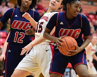 YOUNGSTOWN, OHIO - FEBRUARY 7, 2015: Melita Emanuel-Carr #1 of UIC dribbles away with the basketball after securing the rebound away from Heidi Schlegel #15 of YSU during the 1st half of their game at Beeghly Center Saturday afternoon. (photo by David Dermer/Youngstown Vindicator) Ruvanna Campbell #12 of UIC Pictured.