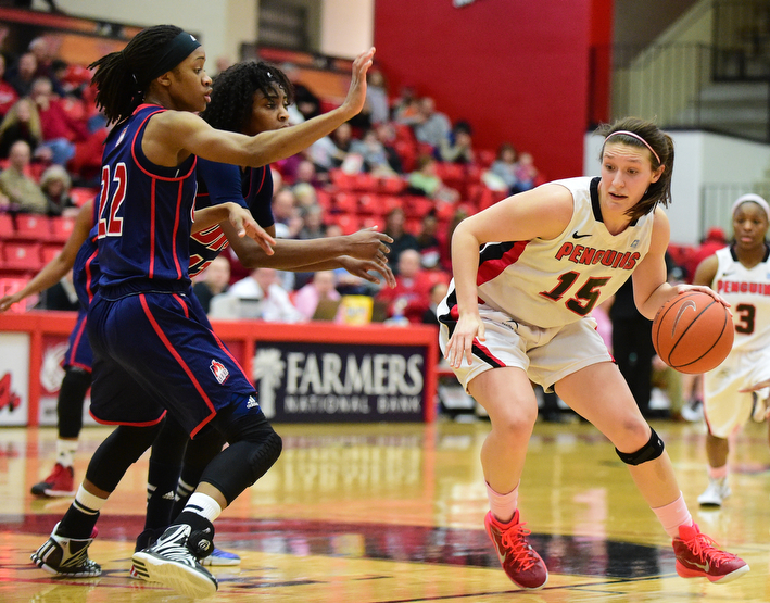YOUNGSTOWN, OHIO - FEBRUARY 7, 2015: Heidi Schlegel #15 of YSU dribbles to the basket while be defended by Imani Moore #22 and Ruvanna Campbell #12 of UIC during the 1st half of their game at Beeghly Center Saturday afternoon. (photo by David Dermer/Youngstown Vindicator)