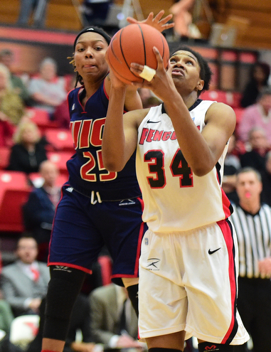 YOUNGSTOWN, OHIO - FEBRUARY 7, 2015: Latisha Walker #34 of YSU puts up a shot while Kendyl Nunn #25 of UIC goes for the block during the 1st half of their game at Beeghly Center Saturday afternoon. (photo by David Dermer/Youngstown Vindicator)