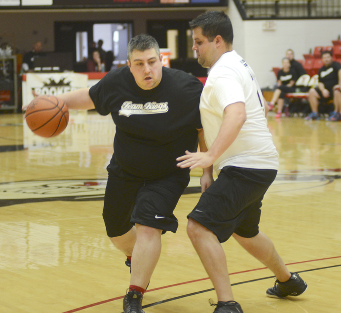 Katie Rickman | The Vindicator.Team Kings Rick Zitkovic moves up the court as team Hope's Andrew Zabel attempts to block him during the first half of the Game of Hope charity event on Feb. 8, 2015 at YSU.