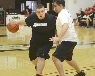 Katie Rickman | The Vindicator.Team Kings Rick Zitkovic moves up the court as team Hope's Andrew Zabel attempts to block him during the first half of the Game of Hope charity event on Feb. 8, 2015 at YSU.