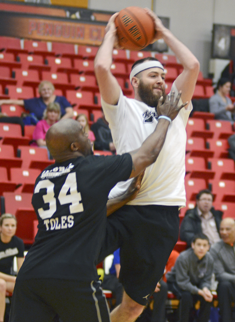 Katie Rickman | The Vindicator.Thomas Seifert (#7) of team Hope jumps in the air and passes the ball as Kings Deryck Toles (#34) of Inspiring Minds attempts to block the pass during the Game of Hope Charity basketball game at YSU on Sunday, Feb 8, 2015.