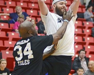 Katie Rickman | The Vindicator.Thomas Seifert (#7) of team Hope jumps in the air and passes the ball as Kings Deryck Toles (#34) of Inspiring Minds attempts to block the pass during the Game of Hope Charity basketball game at YSU on Sunday, Feb 8, 2015.