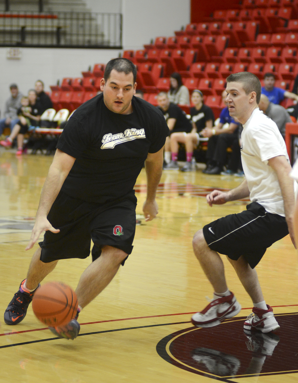 Katie Rickman | The Vindicator.Team Kings' Justin Turner (#8) shoots and scores as team Hope's Chase Evans (#3) attempts the block him during the first half of the Game of Hope Charity basketball game at YSU Sunday, Feb. 8, 2015.