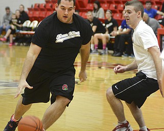 Katie Rickman | The Vindicator.Team Kings' Justin Turner (#8) shoots and scores as team Hope's Chase Evans (#3) attempts the block him during the first half of the Game of Hope Charity basketball game at YSU Sunday, Feb. 8, 2015.