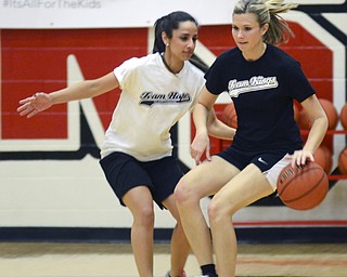 Katie Rickman | The Vindicator.Team Kings Lisa Stroney (#21) moves up court team Hope's Cristina Esparra (#27) guards her during the first half of the Game of Hope charity event on Feb. 8, 2015 at YSU.