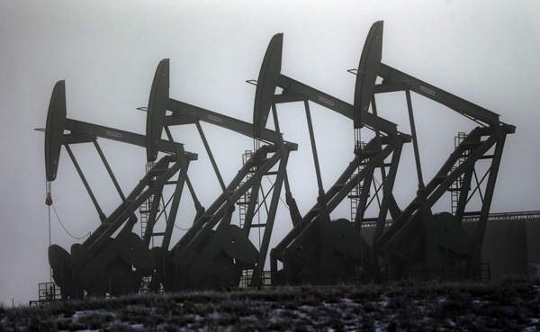 Oil-pump jacks work in unison in Williston, N.D. After falling nearly 60 percent from a peak last June, the price of oil has bounced back 19 percent since late January.