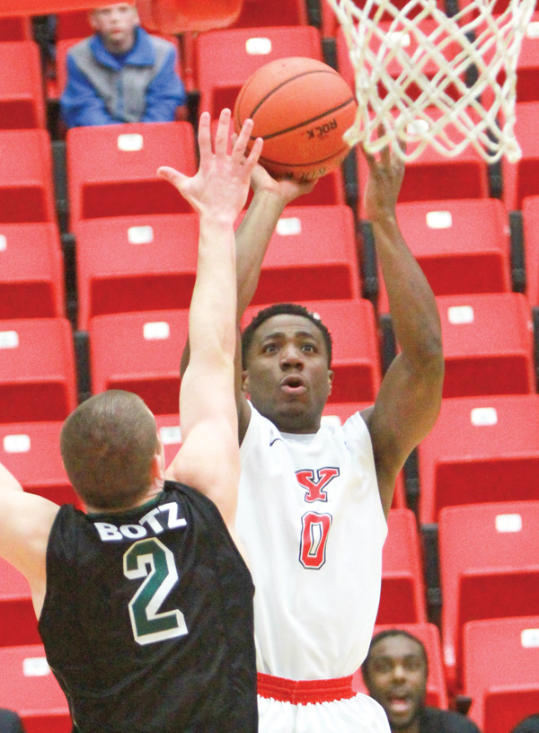 Youngstown State’s Shaun Stewart shoots over Green Bay’s Turner Botz during their game Wednesday at YSU’s Beeghly Center. The Penguins were leading by 10 points late in the second half but couldn’t hold off the Phoenix, who won 63-62.