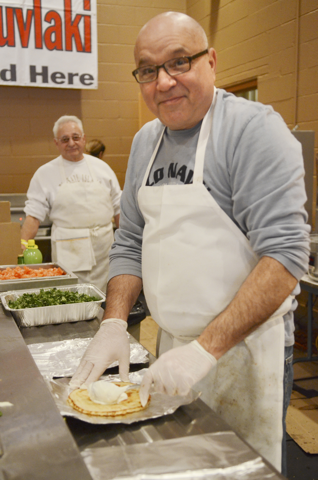 Katie Rickman | The Vindicator.Dean Paidas of Warren prepares a Souvlaki Gyro during the first night of the Greek Festival at Archangel Michael Greek Orthodox Church in Campbell on Friday, Feb. 13, 2015.